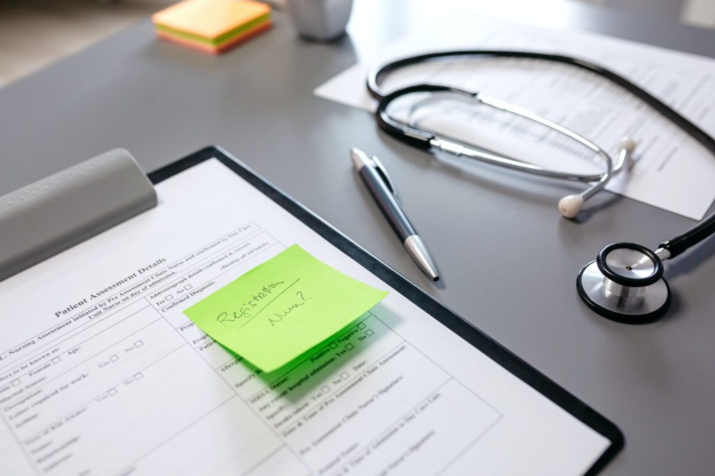 Doctor desk with documents and stethoscope