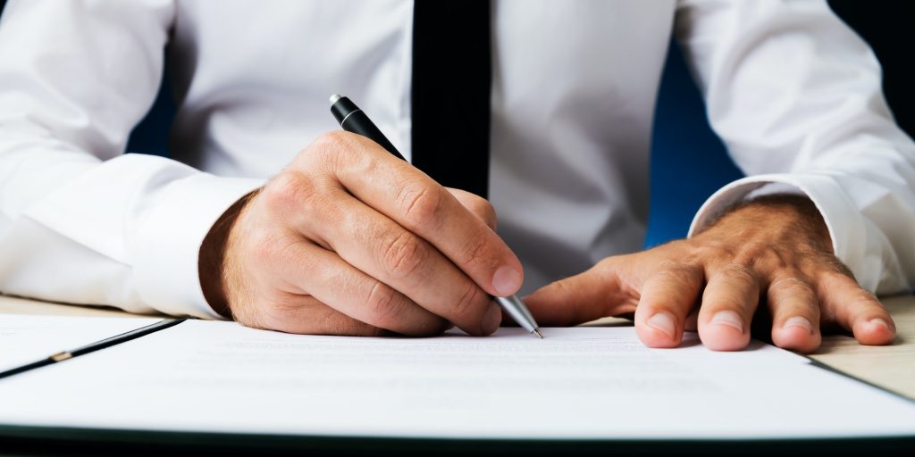 Businessman signing document